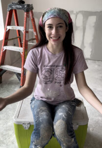 young girl smiling in house being constructed.