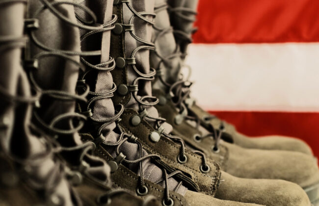 Military boots in front of the American flag for serving those who have served.