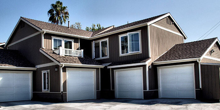 Large brown apartment's with garages.