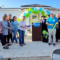 a group of people at a ceremony in honor of a new home