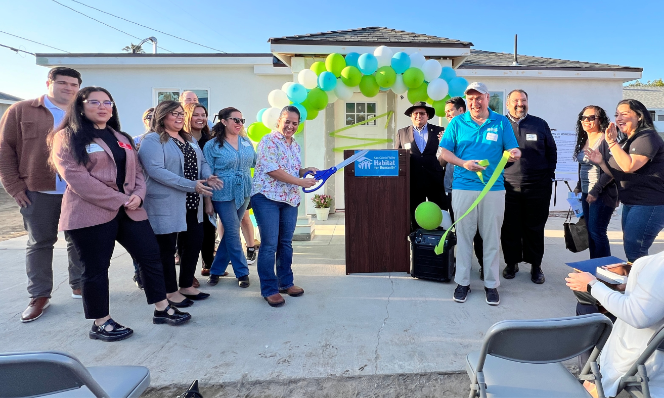 a group of people at a ceremony in honor of a new home