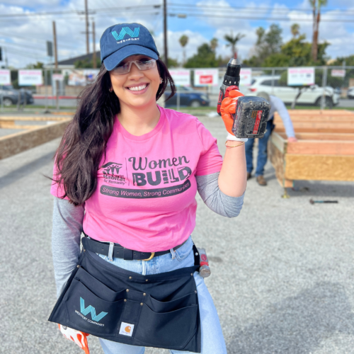 Woman on a construction site holding a drill