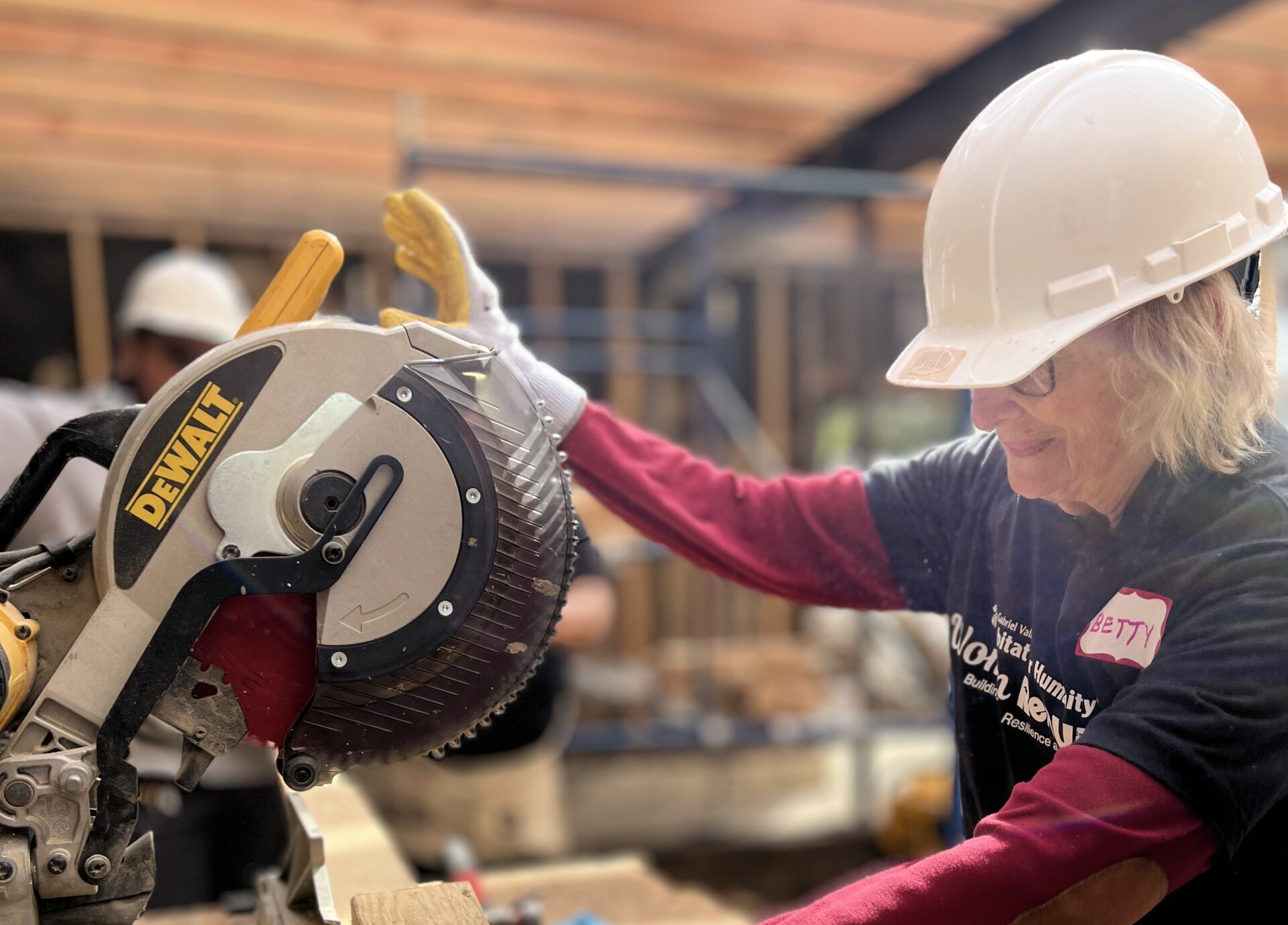 woman using saw during women build 2025 event