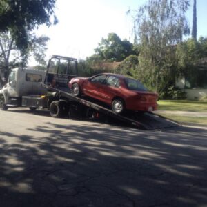 car being loaded on a tow truck being donated to cars for homes