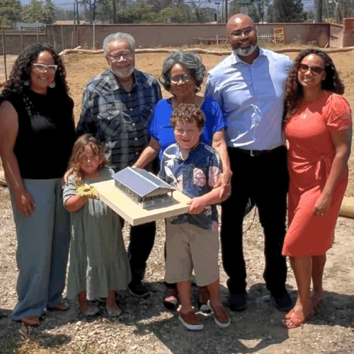 wood family posing with house model