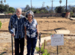 couple standing on empty lot