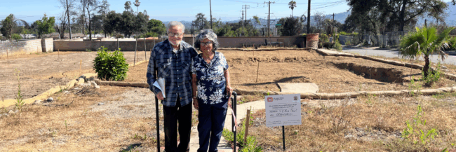 couple standing on empty lot