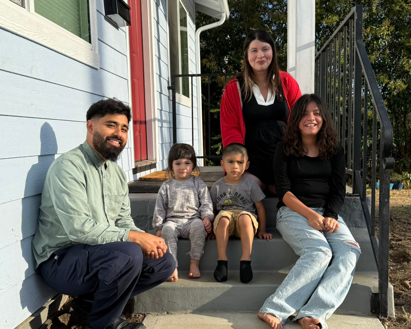 Family of 5 sitting on a front porch