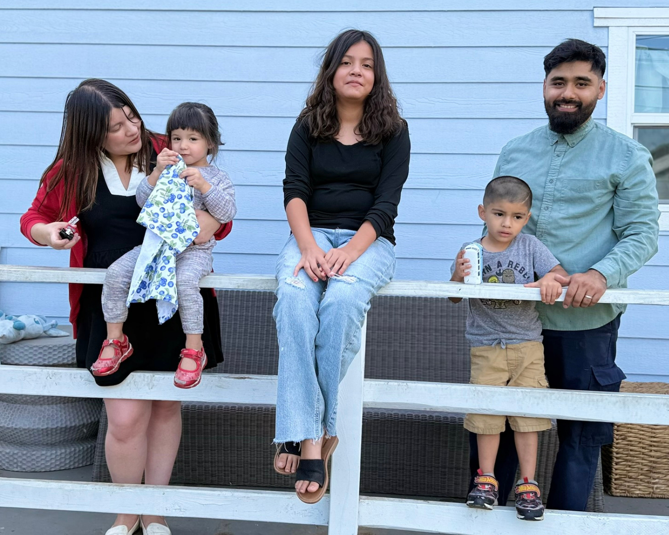 family of 5 hanging out on a deck