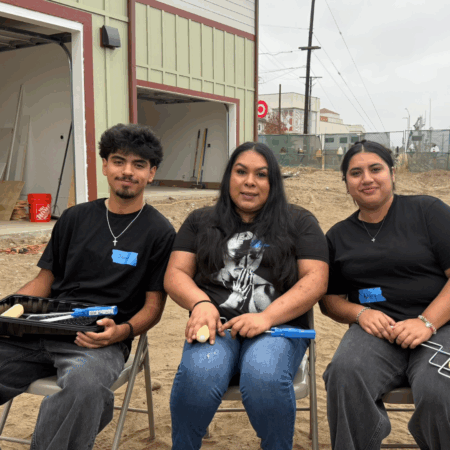 son, mother and daughter sitting near eachother