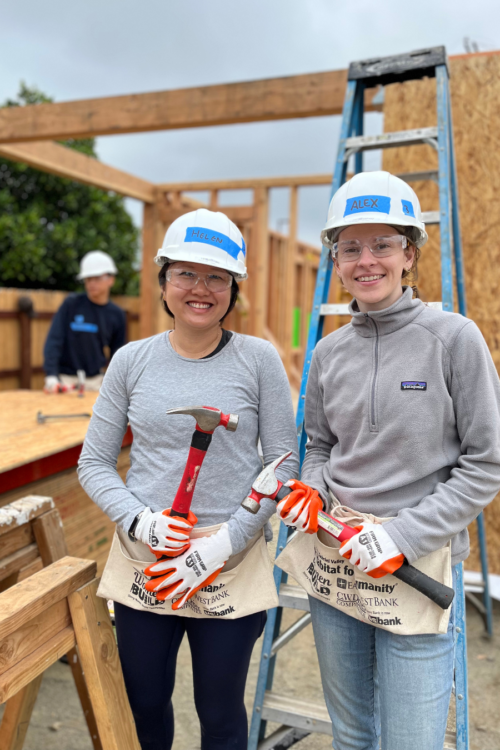 two volunteers holding tools