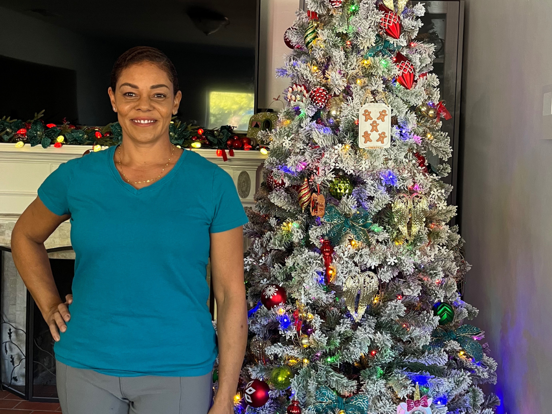 woman standing in front of a christmas tree