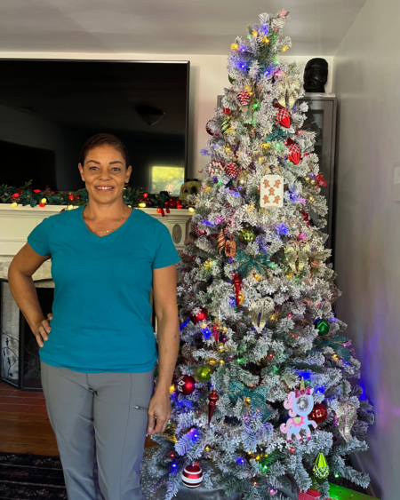 woman standing in front of a christmas tree