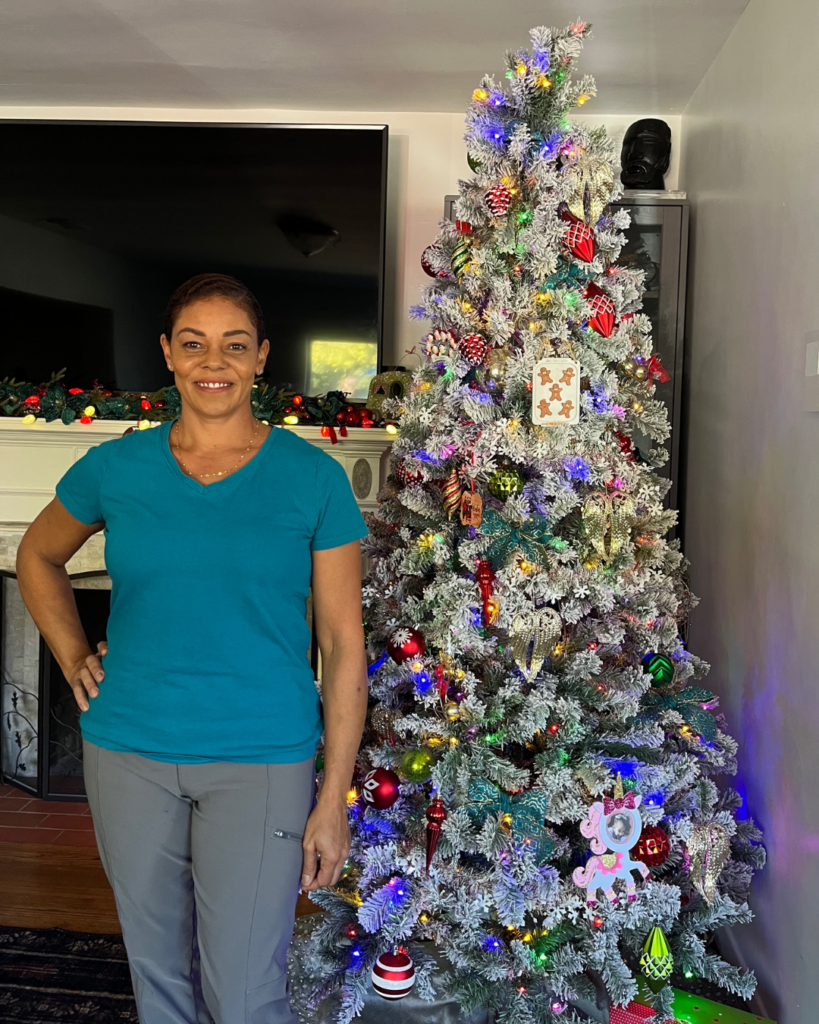 woman standing in front of a christmas tree