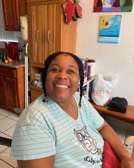 A woman smiling and wearing a blue shirt