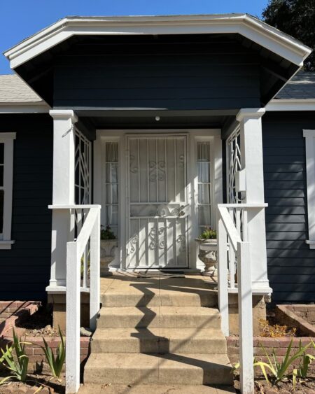 Painted and clean front porch with dark blue paint