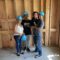 Family standing on the concrete floor of a home under construction