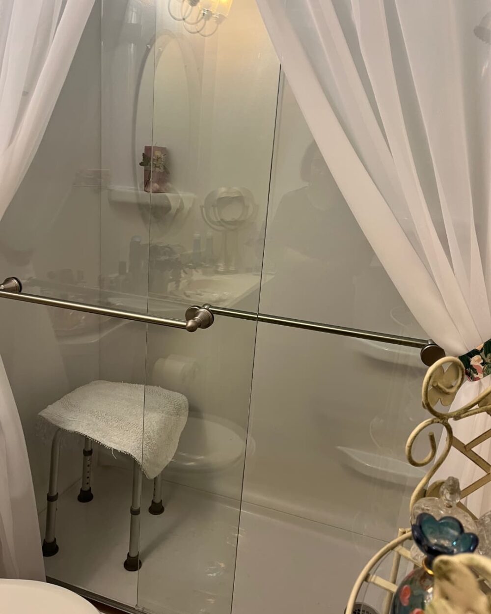 New, white bathroom with seating