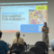 Presenter speaking at a San Gabriel Valley Habitat for Humanity rebuilding information session for Eaton Fire survivors.