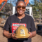 homeowner posing with gold hard hat