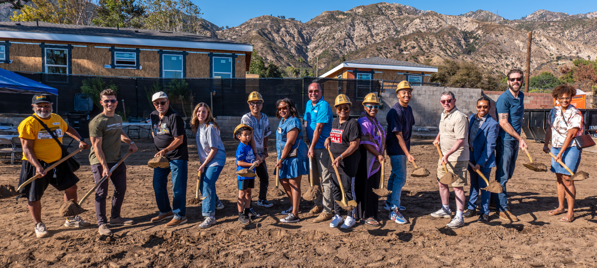 homeowner with friends, family and sgvhabitat staff holding shovels at the groundbreaking.