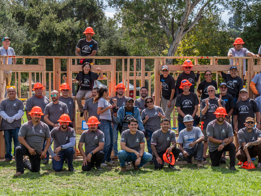 lead volunteers smiling in a large group photo