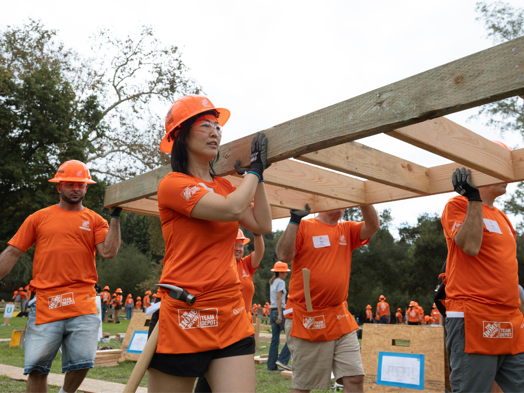 volunteers carrying a wall