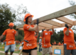 volunteers carrying a wall