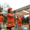 volunteers carrying a wall