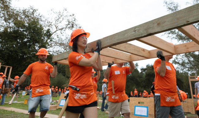 Home Depot Build volunteers carrying a wall