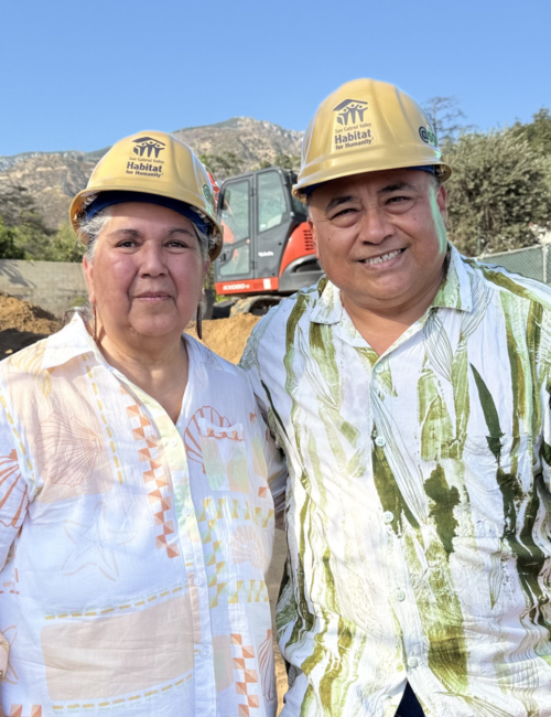 couple standing on their empty lot
