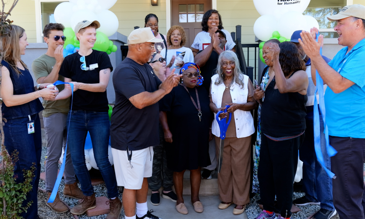 group of people celebrating a ribbon cutting