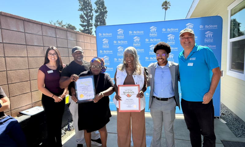 six people posing for a photo holding certificates