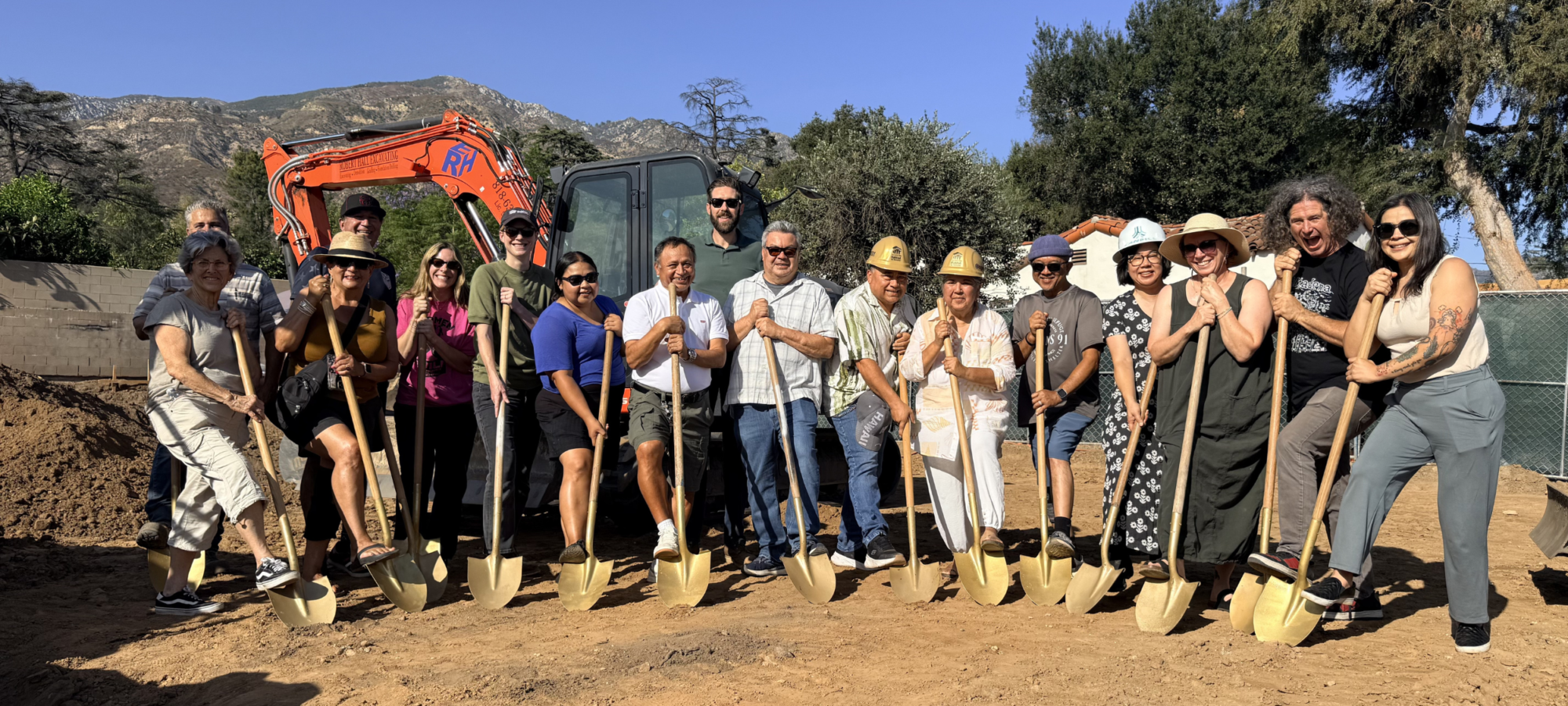 group holding shovels at a groundbreaking event