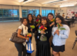students posing with flowers