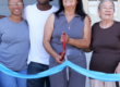 family cutting the ribbon