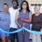 family cutting the ribbon