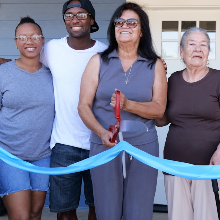 family cutting the ribbon