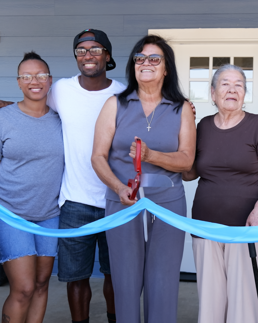 family cutting the ribbon